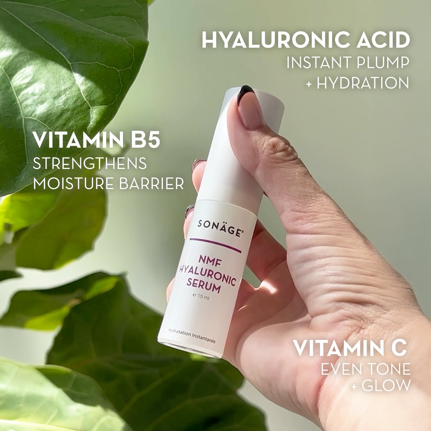 Hand holding a Sonáge NMF Hyaluronic Serum with green leaves in the background