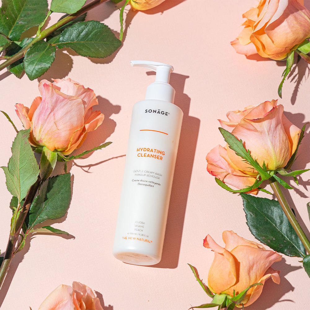 cleanser on peach background surrounded by roses