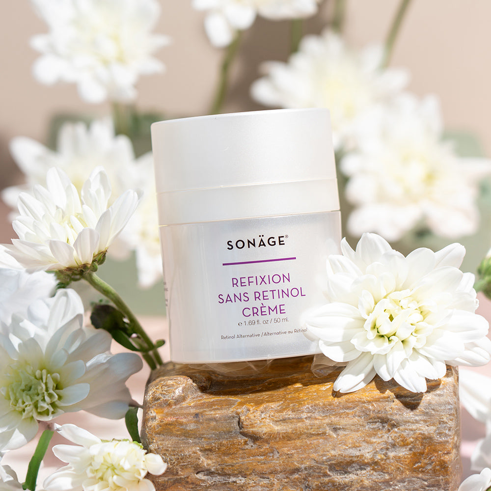 moisturizer surrounded by white flowers
