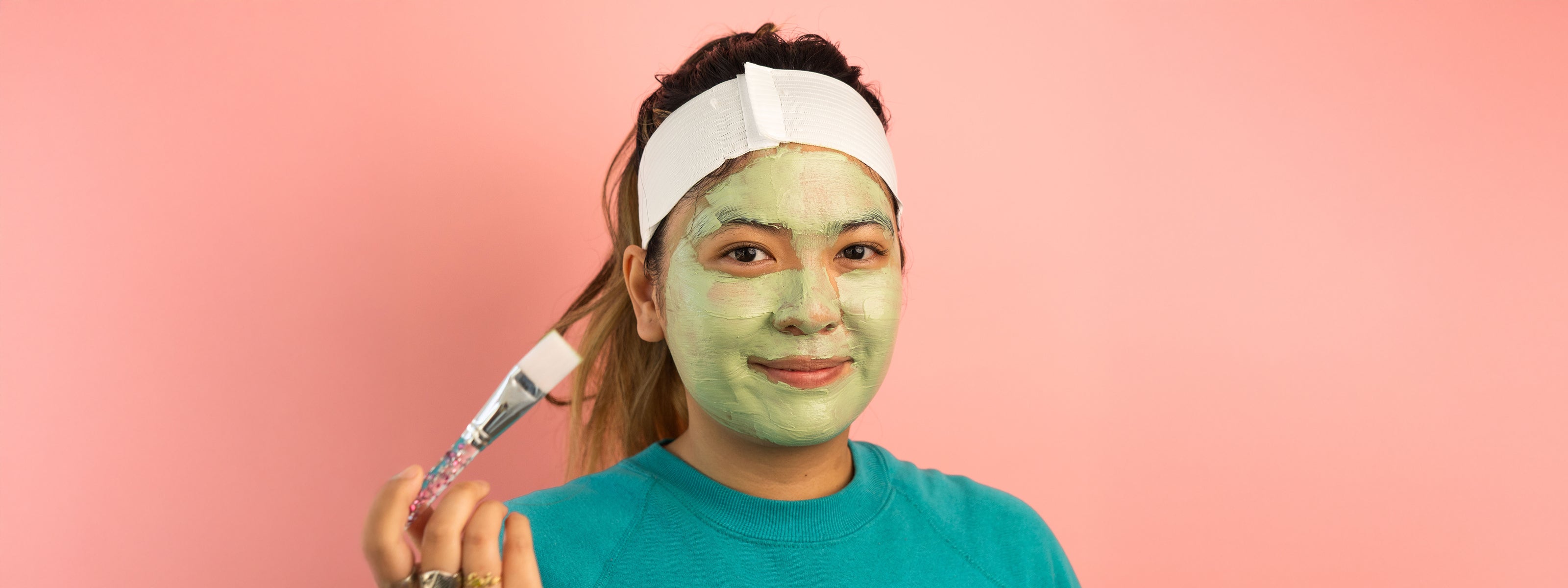 woman using and applying tulsi mask
