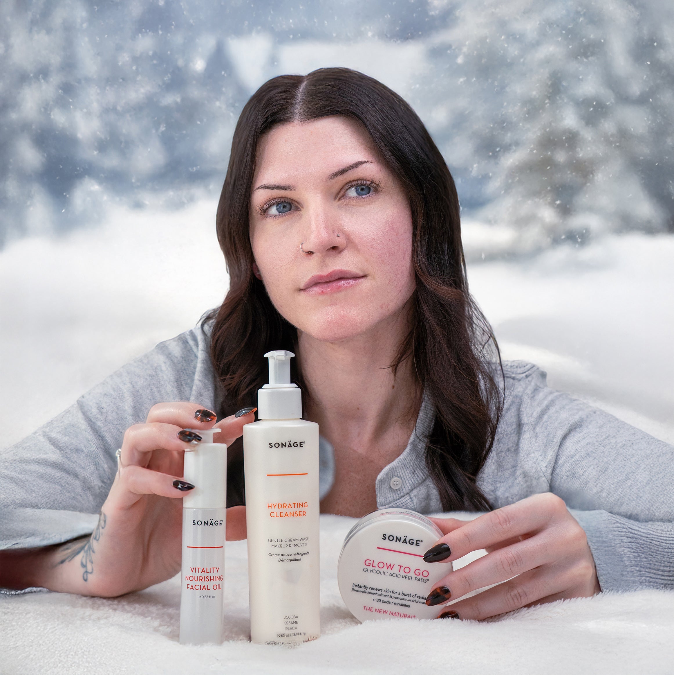 Woman holding skincare products with a snowy background